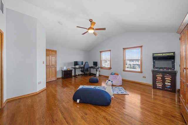 sitting room with vaulted ceiling, baseboards, visible vents, and wood finished floors