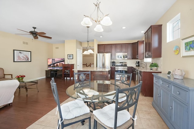 dining room with light tile patterned floors, visible vents, recessed lighting, and baseboards