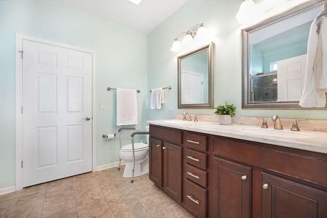 bathroom featuring tile patterned flooring, double vanity, a shower with door, and a sink