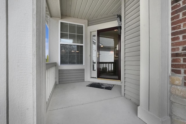 entrance to property featuring brick siding