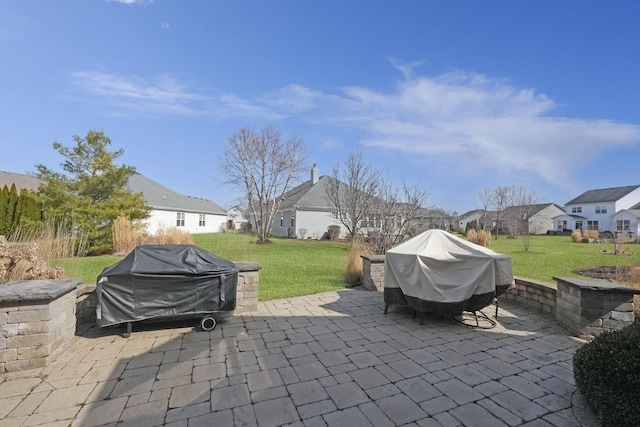 view of patio / terrace with area for grilling and a residential view