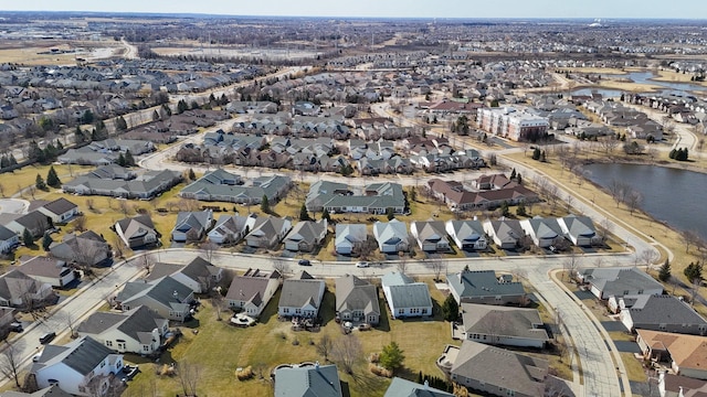 birds eye view of property featuring a residential view and a water view