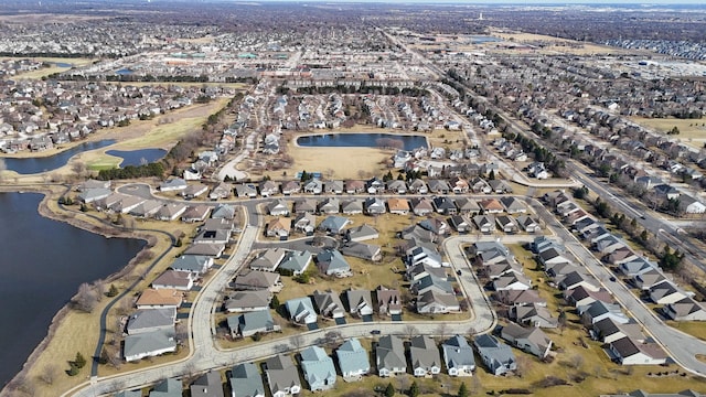 bird's eye view with a residential view and a water view