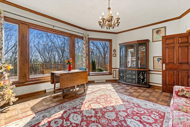 interior space featuring baseboards, ornamental molding, baseboard heating, a notable chandelier, and a textured ceiling