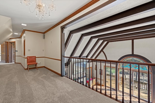 hall with baseboards, lofted ceiling, carpet flooring, and crown molding