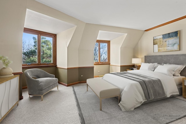 bedroom with baseboards, light carpet, and vaulted ceiling