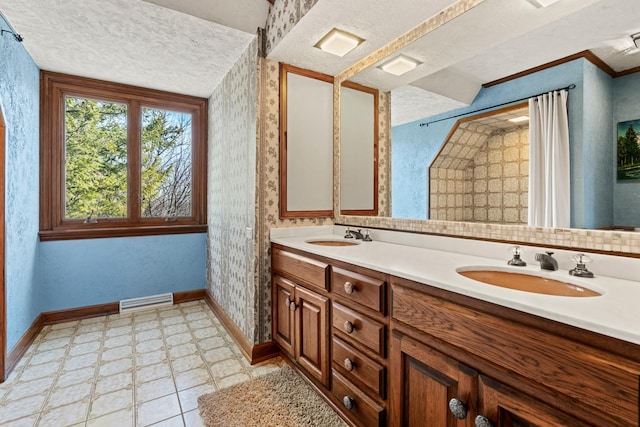 full bathroom featuring a sink, visible vents, baseboards, and a textured ceiling