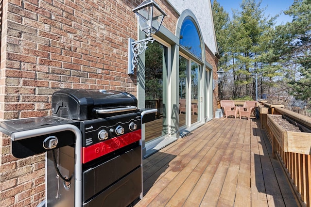 wooden deck with a grill