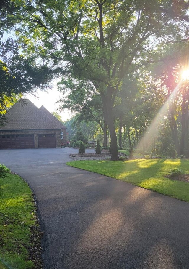 view of side of home with a lawn and a garage