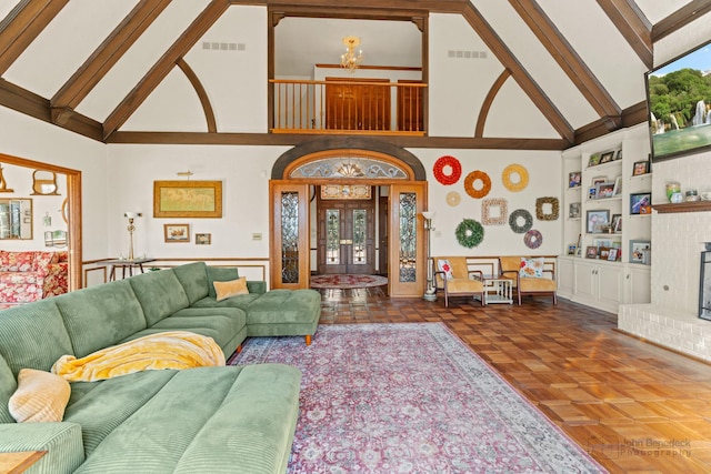 living area featuring built in features, visible vents, a healthy amount of sunlight, and a fireplace