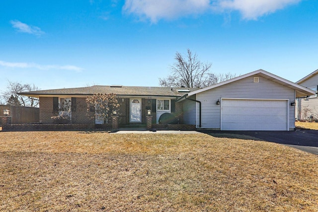 single story home with brick siding, aphalt driveway, a garage, and a front yard