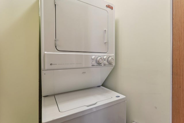 laundry area with laundry area and stacked washer / drying machine