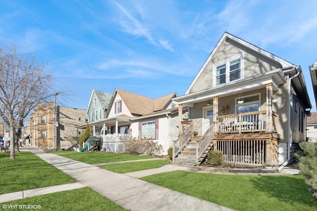 bungalow featuring a residential view, covered porch, and a front lawn