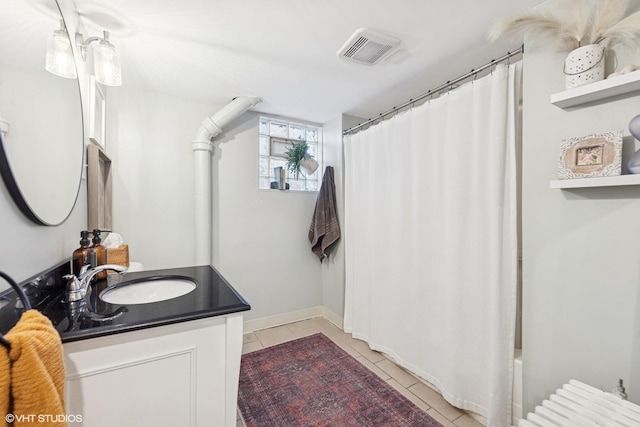 full bath featuring vanity, visible vents, baseboards, shower / bath combo, and tile patterned floors