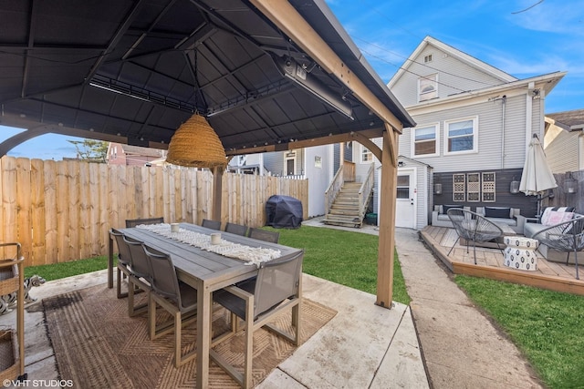 view of patio / terrace with a grill, outdoor dining area, and fence