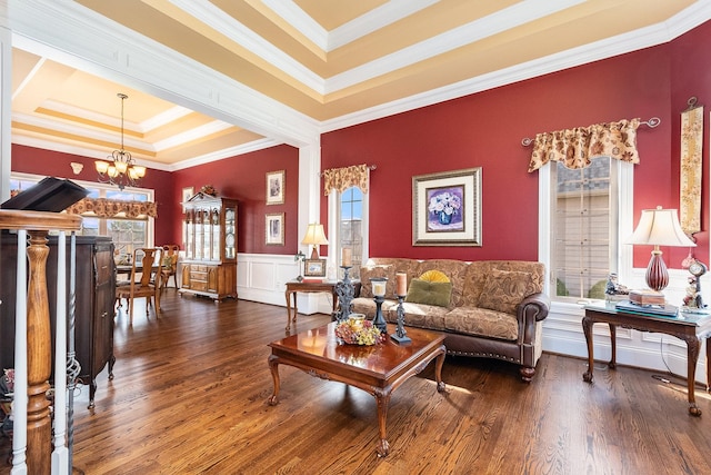 living room with dark wood finished floors, a notable chandelier, and plenty of natural light