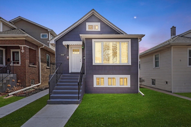 view of front of property with a lawn