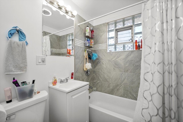 bathroom with toilet, shower / bath combo, and vanity