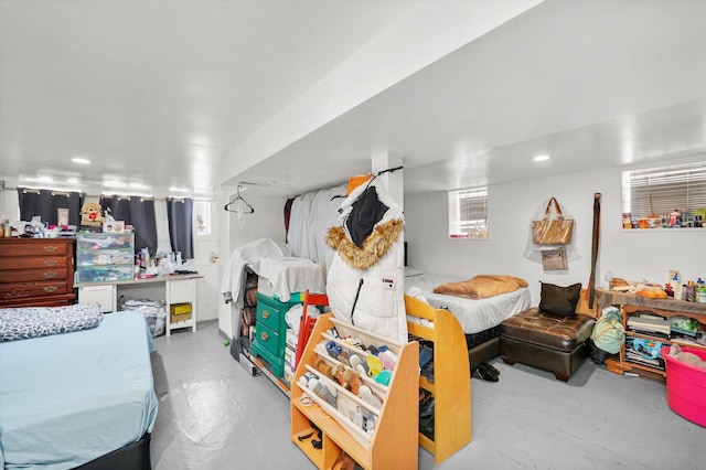 bedroom with recessed lighting and finished concrete flooring