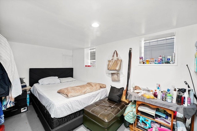 bedroom with recessed lighting and concrete flooring