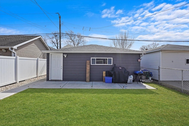 rear view of property with a lawn, fence private yard, a patio, and a shingled roof