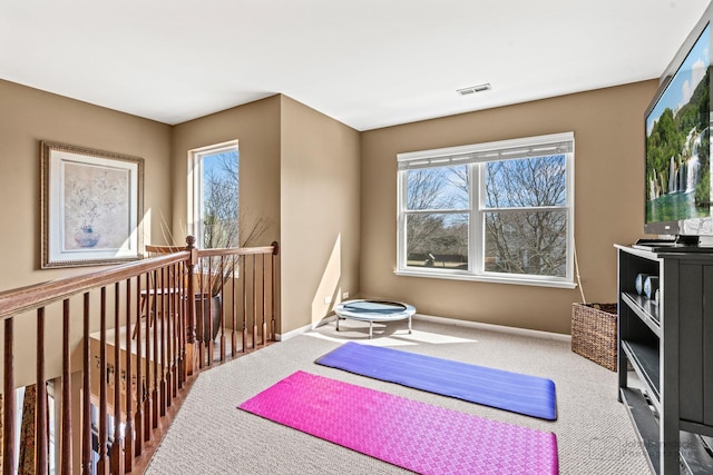 workout room featuring visible vents, carpet flooring, and baseboards