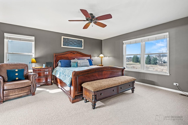 carpeted bedroom with a ceiling fan and baseboards