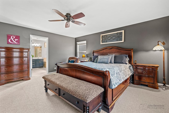 carpeted bedroom featuring ceiling fan, ensuite bathroom, and baseboards