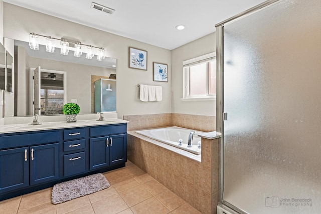 bathroom featuring visible vents, a stall shower, tile patterned flooring, double vanity, and a bath