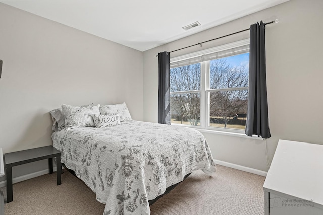 bedroom featuring baseboards, visible vents, and carpet floors