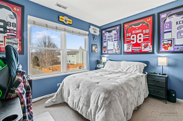 bedroom with visible vents, baseboards, and carpet