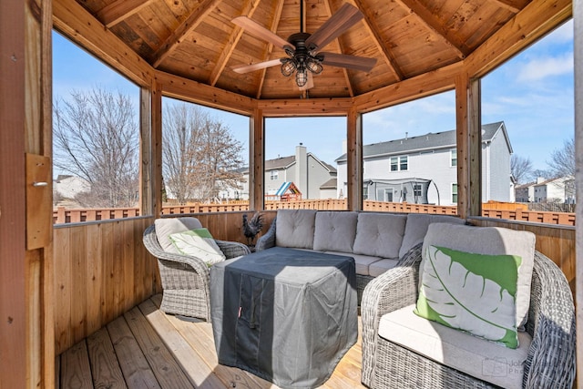 sunroom with wooden ceiling, lofted ceiling with beams, and a ceiling fan