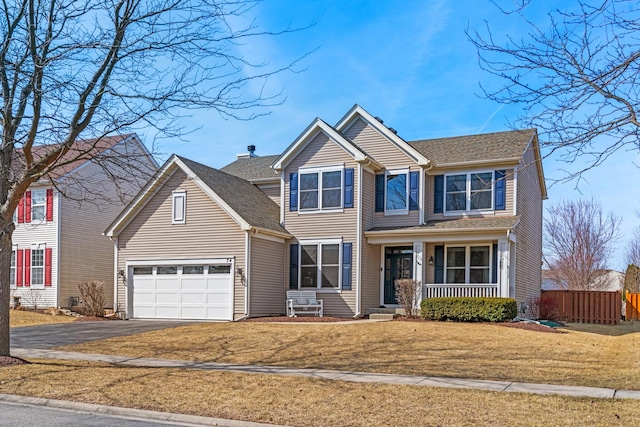 view of front of home with aphalt driveway, fence, covered porch, a front yard, and a garage