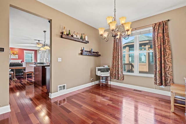 dining area with a healthy amount of sunlight, visible vents, and wood-type flooring