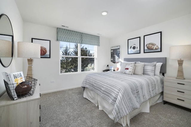 carpeted bedroom featuring visible vents and baseboards