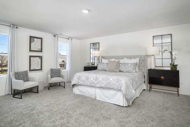 bedroom featuring baseboards and carpet