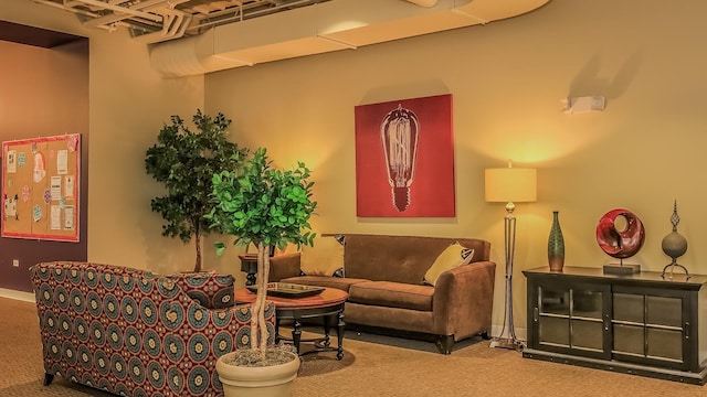 carpeted living area featuring baseboards