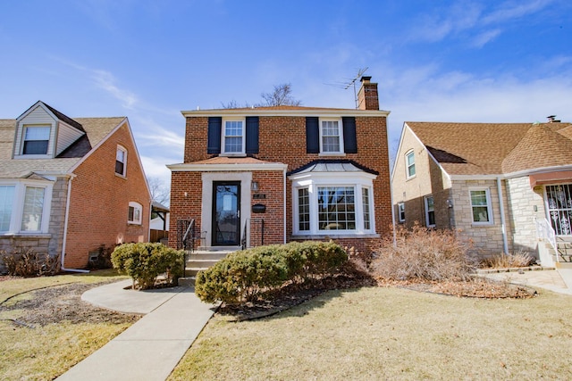 traditional-style house with a front lawn, brick siding, and a chimney