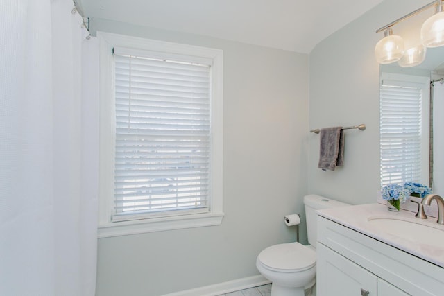 full bath featuring curtained shower, baseboards, toilet, and vanity