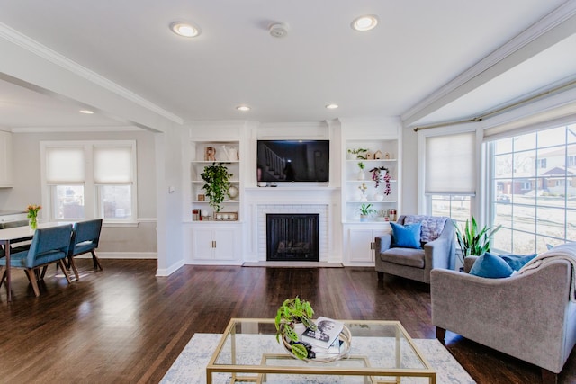 living room featuring plenty of natural light, dark wood-type flooring, a brick fireplace, and ornamental molding