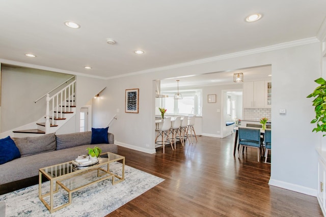 living room featuring stairway, baseboards, dark wood-style floors, and ornamental molding