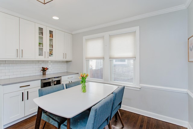 kitchen with ornamental molding, glass insert cabinets, decorative backsplash, baseboards, and dark wood-style flooring