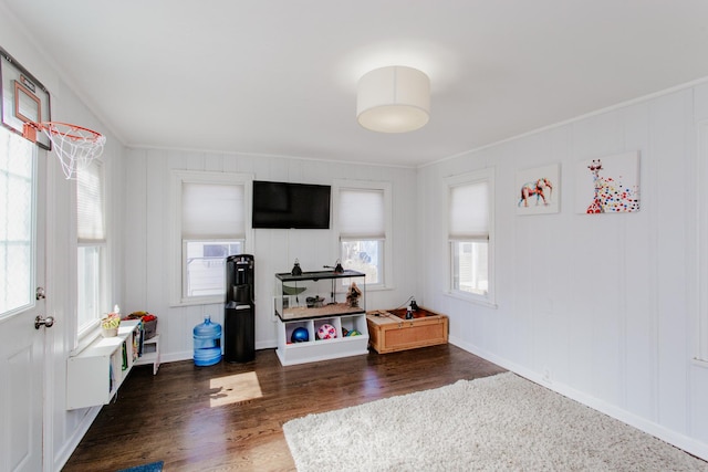 recreation room featuring crown molding, wood finished floors, and baseboards