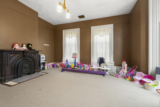 rec room with lofted ceiling, carpet, and a fireplace