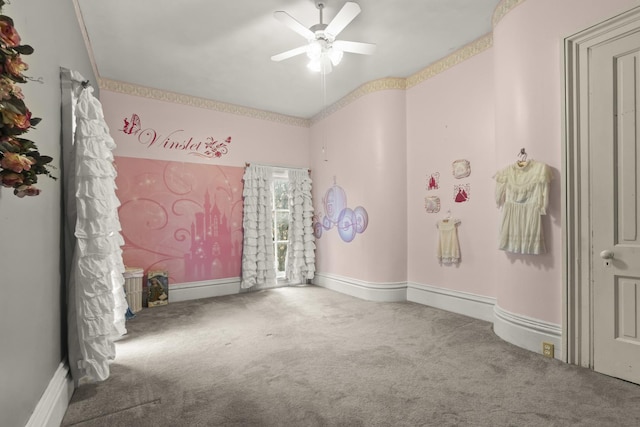 unfurnished room featuring baseboards, a ceiling fan, and carpet