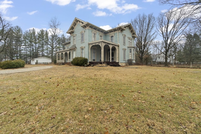 italianate-style house with a front yard and fence