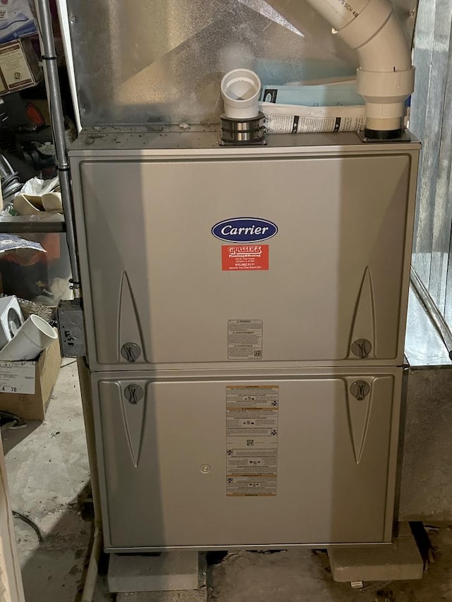 utility room featuring heating unit