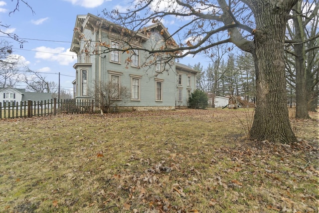 view of side of property featuring fence