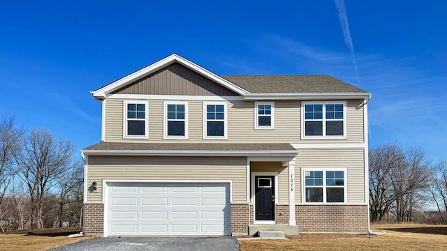 view of front facade featuring a garage, brick siding, driveway, and a shingled roof