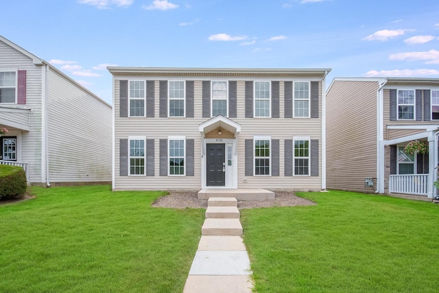 colonial home featuring a front yard